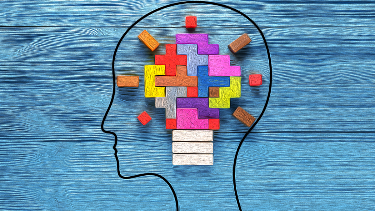 abstract image of head with puzzle pieces forming a lightbulb