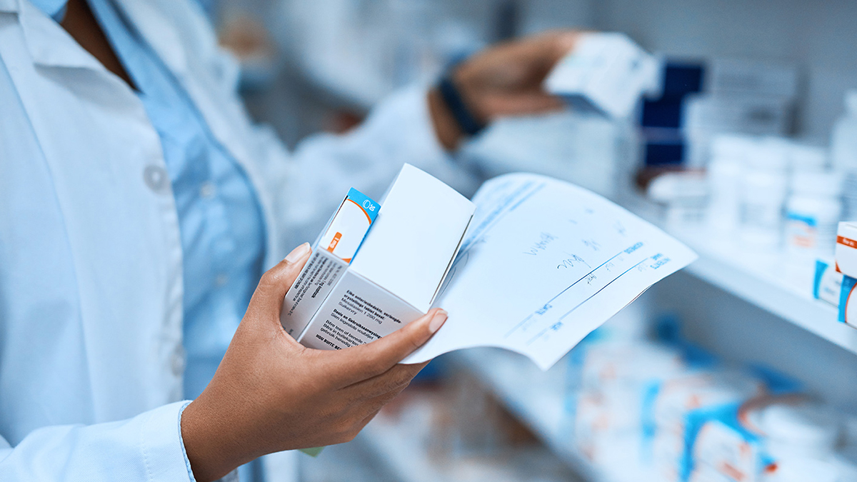 Cropped shot of a pharmacist filling a prescription at a chemist