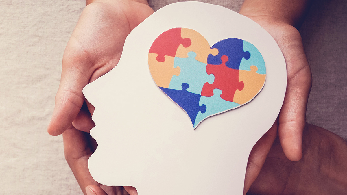 abstract image of head with a puzzle heart inside