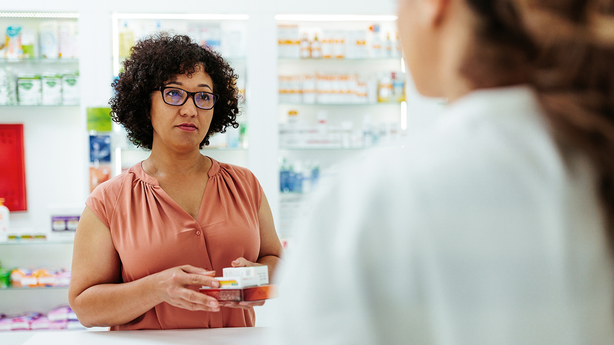 Customer in pharmacy at checkout with medication
