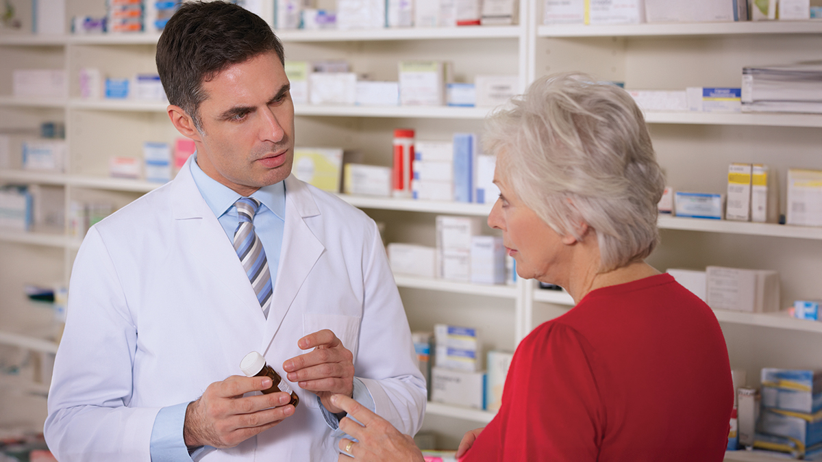 Pharmacist with senior woman in pharmacy