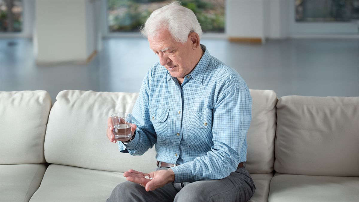 Senior man taking medication