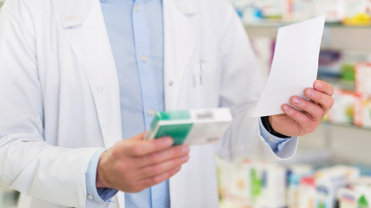 Pharmacist filling prescription in pharmacy