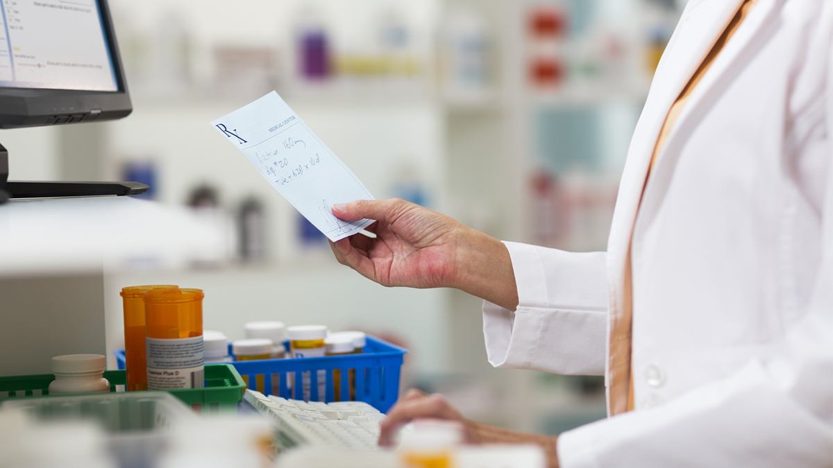 pharmacist looking at prescription
