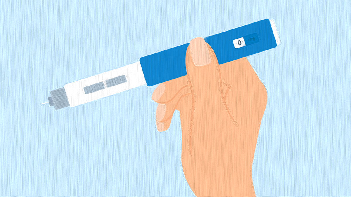 Hand Holding Insulin Injection Pen On Blue Background