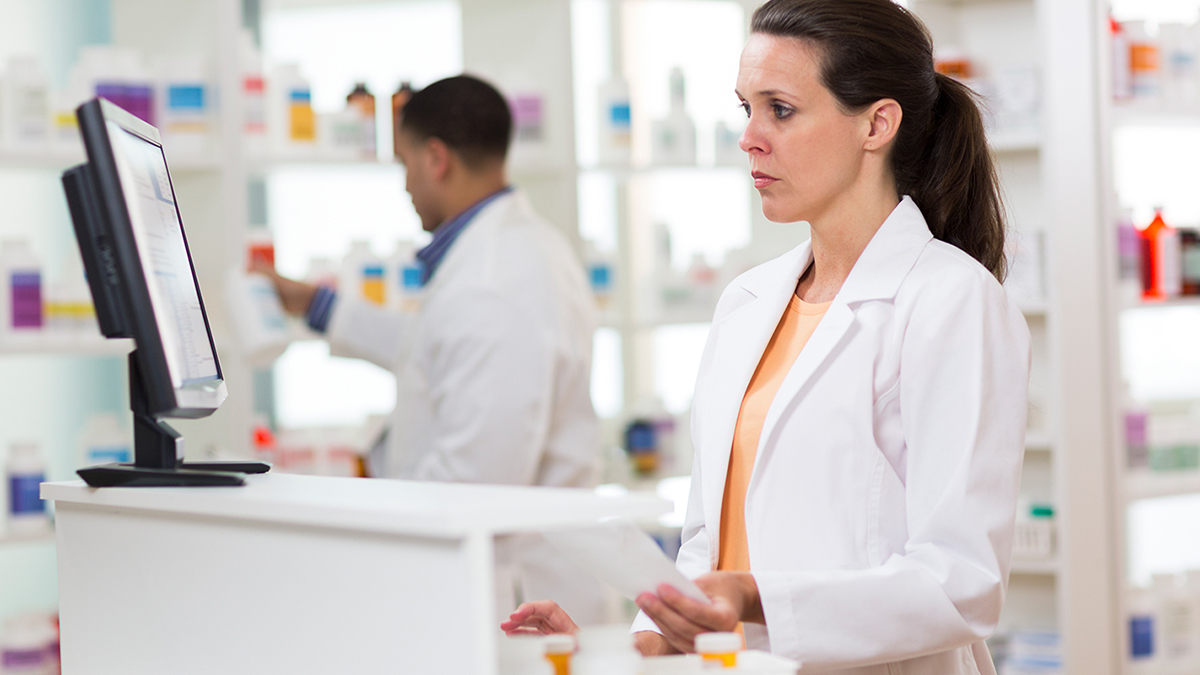 pharmacist looking a prescription