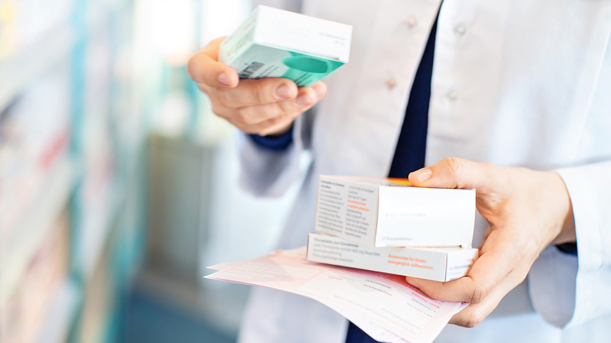 pharmacist handling a box of medication