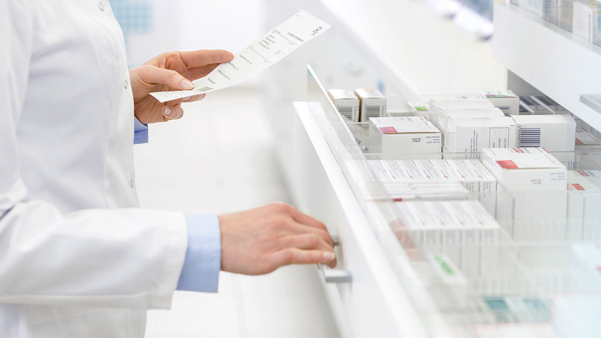 pharmacist checking prescription