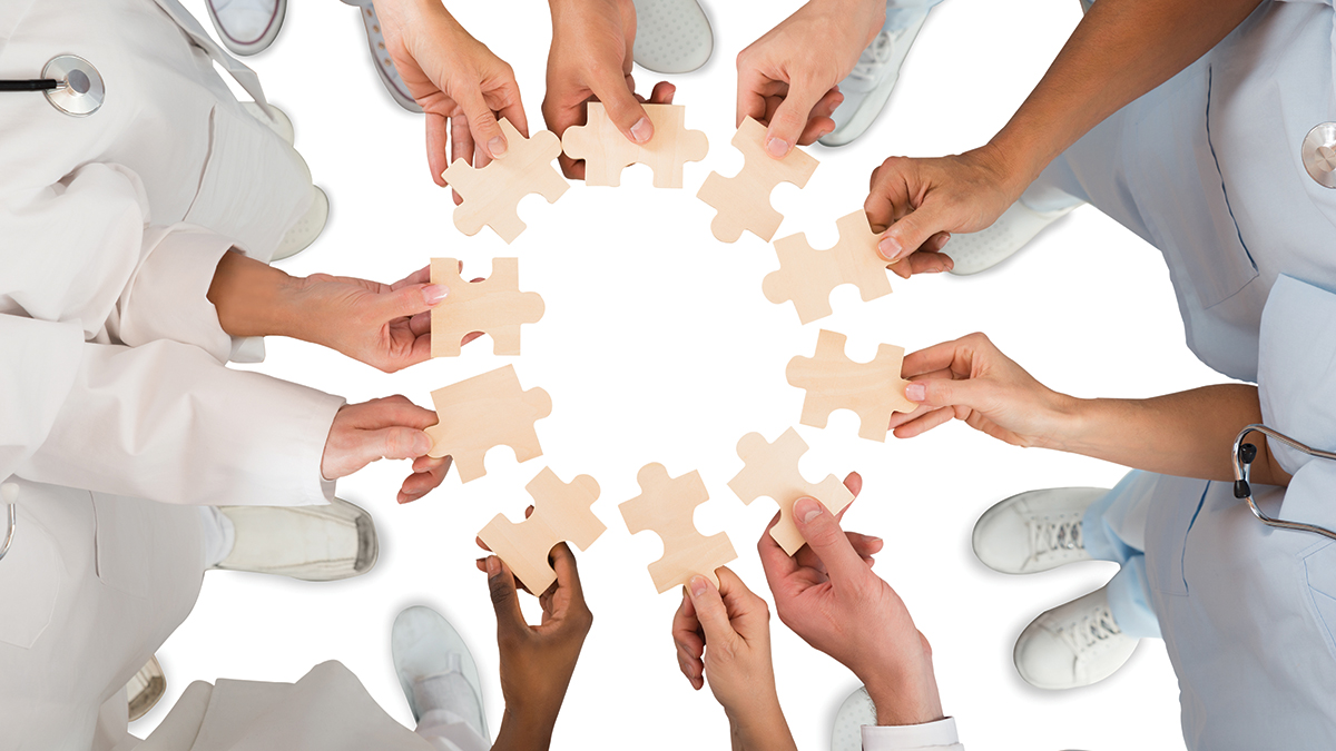 medical team holding jigsaw pieces