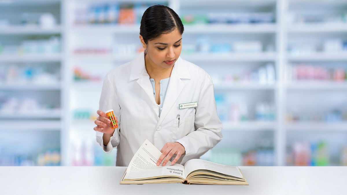 pharmacist looking at book
